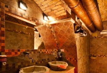 Apollion Sauna Rome interior. Tiled walls, sinks, mirror, and brick ceiling. Gay sauna travel advice, Apollion is a popular destination.