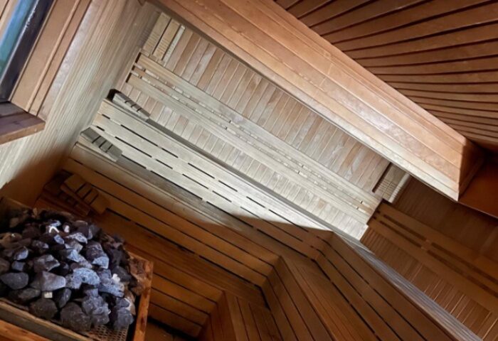 Aquarius Sauna Istanbul: interior view. Wooden benches, walls, and ceiling. Rocks for heat. Gay sauna experience in Turkey's largest city.