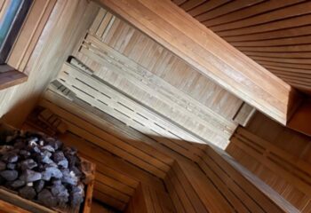 Aquarius Sauna Istanbul: interior view. Wooden benches, walls, and ceiling. Rocks for heat. Gay sauna experience in Turkey's largest city.