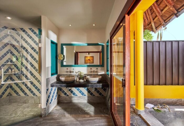 SAii Phi Phi Island Village's Artzy Pool Villa beachfront bathroom. Double sinks, tiled shower, and outdoor bath. Gay travel luxury.