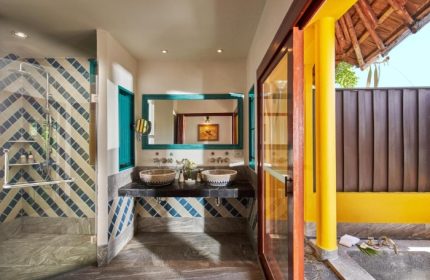 SAii Phi Phi Island Village's Artzy Pool Villa beachfront bathroom. Double sinks, tiled shower, and outdoor bath. Gay travel luxury.