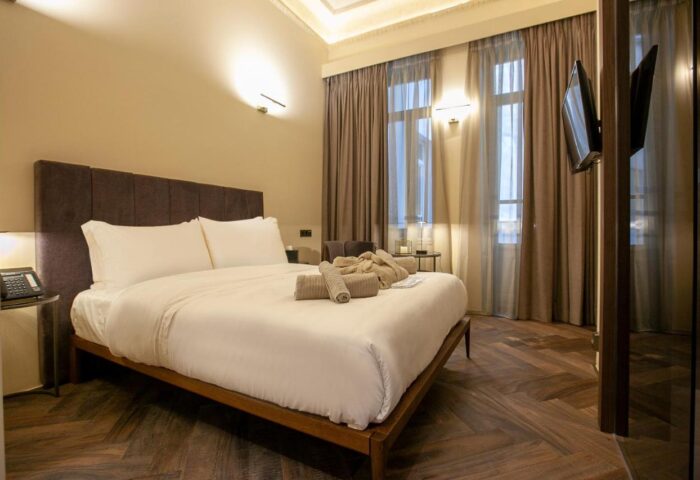 Athens 1890 Hotel room. Gay-friendly hotel with a king-size bed, towels, and a robe. Adults-only hotel in Athens, Greece.