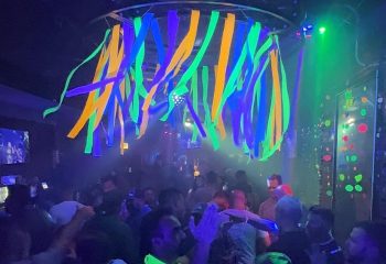 Atmosphere Bar in Andersonville, Chicago. A lively gay bar with live music, a dance floor, and colorful decorations. Gay nightlife travel.