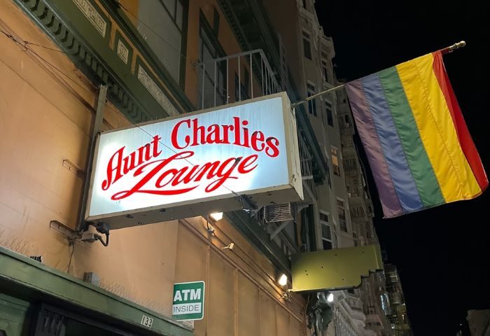 Aunt Charlie's Lounge in San Francisco. Gay bar with rainbow flag. Night view of the bar's sign. Gay travel advice.
