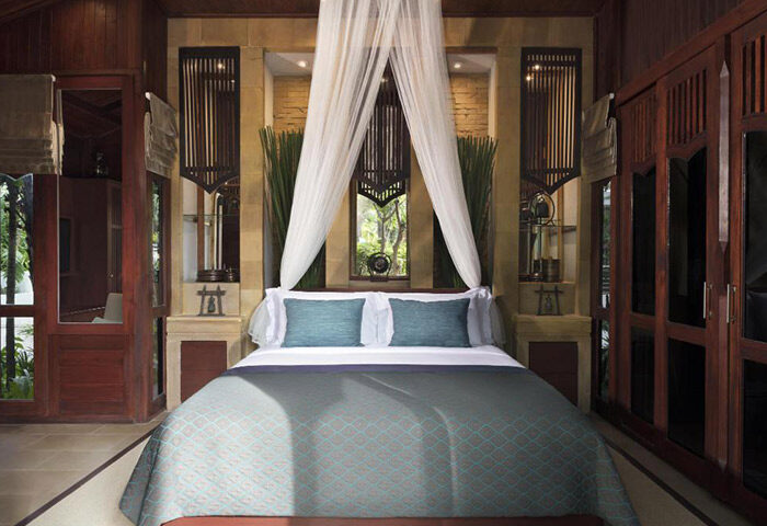Avani Pattaya Resort villa bedroom. Luxury gay hotel near gay bars in Pattaya City, Thailand. Comfortable bed with canopy.