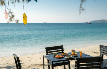 Avatara Resort Koh Samet beachfront dining. Table set for breakfast on the beach. Popular gay hotel destination.