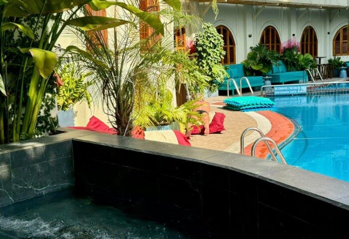 Azure Pool Bar, Ho Chi Minh. Gay travel: Poolside relaxation with turquoise couches, tropical plants, and a refreshing pool. Ideal for gay travelers.