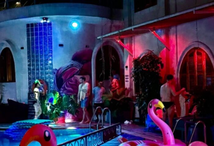 Azure Pool Bar Ho Chi Minh: Gay men mingle poolside at night. Pink flamingo floats add fun to this Vietnam travel hot spot.