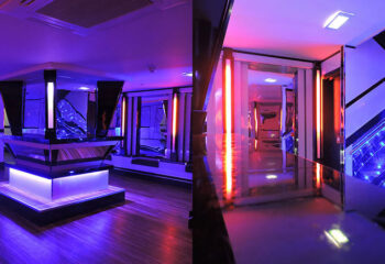 Interior of BJ's White Swan gay club. Bar, stage, and hallway with neon lighting. Gay travel advice. BJs-White-Swan-Gay-Club.jpg