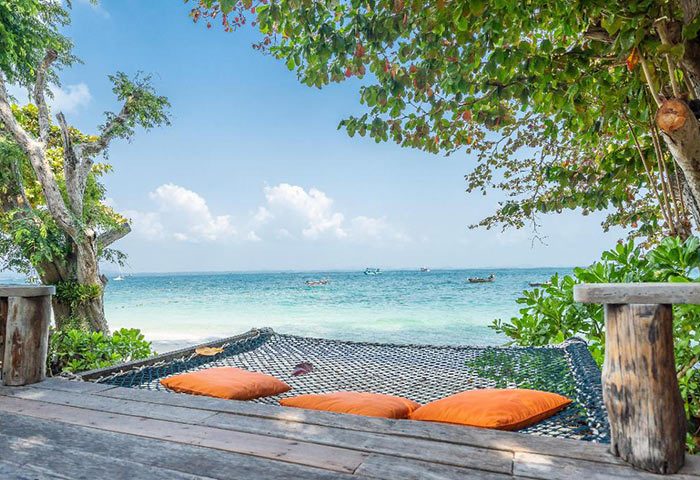 Baan Ploy Sea, Koh Samet: Hammock with orange pillows on a wooden deck overlooking the beach. Gay hotel for a cheap, quiet beachfront stay.