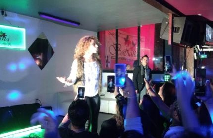 Babilonia Baby Club gay bar in Mexico: Drag queen performing on stage as people record with phones. Gay nightlife travel advice.