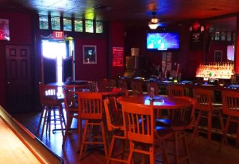 Badlands Las Vegas: Interior view of the gay bar, showing tables, chairs, bar area, and TV screen, offering travel advice for gay men.