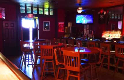 Badlands Las Vegas: Interior view of the gay bar, showing tables, chairs, bar area, and TV screen, offering travel advice for gay men.
