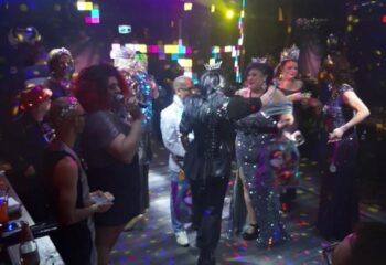 Badlands Las Vegas gay bar scene. Drag queens with crowns, one singing, at a pageant show. Gay nightlife in Las Vegas.