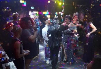 Badlands Las Vegas gay bar scene. Drag queens with crowns, one singing, at a pageant show. Gay nightlife in Las Vegas.