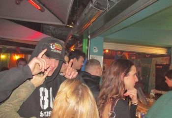 Baggen Copenhagen: Gay men at a bar in Copenhagen, Denmark. The man in the foreground is wearing a black hoodie and a baseball cap.