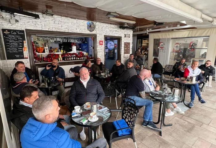 Baloo Bar Lounge, a gay bar in Torremolinos: a group of men are sitting at tables, drinking coffee and chatting. A popular gay travel spot.