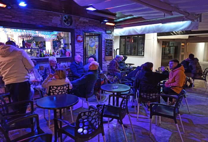 Baloo Bar lounge, a gay bar in Torremolinos, Spain. People sit at tables outside, enjoying drinks in the vibrant, welcoming atmosphere.