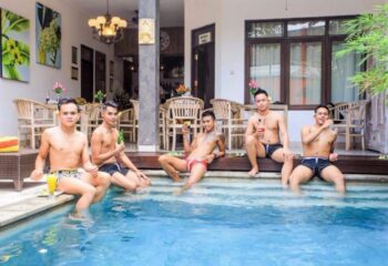 Gay men at Banana Spa Bali enjoy drinks by the pool. Instagram-worthy massage in Seminyak. Gay travel in Bali.
