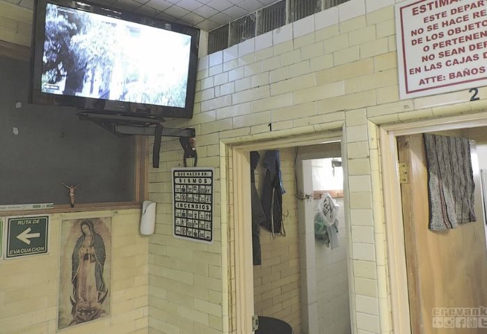 Finisterre Gay Sauna in Mexico: Interior view with TV, religious iconography, and safety instructions. A unique travel experience for gay men.
