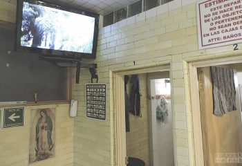 Finisterre Gay Sauna in Mexico: Interior view with TV, religious iconography, and safety instructions. A unique travel experience for gay men.