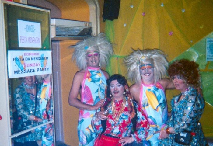 Drag queens at a Lisbon gay bar, Bar 106, during a Sunday message party. Colorful costumes and wigs, part of Lisbon's gay nightlife scene.