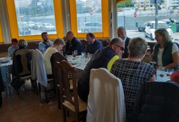 People dine at Bar Babel, a gay bar in Torremolinos. The restaurant has checkered tablecloths and a view of the city.