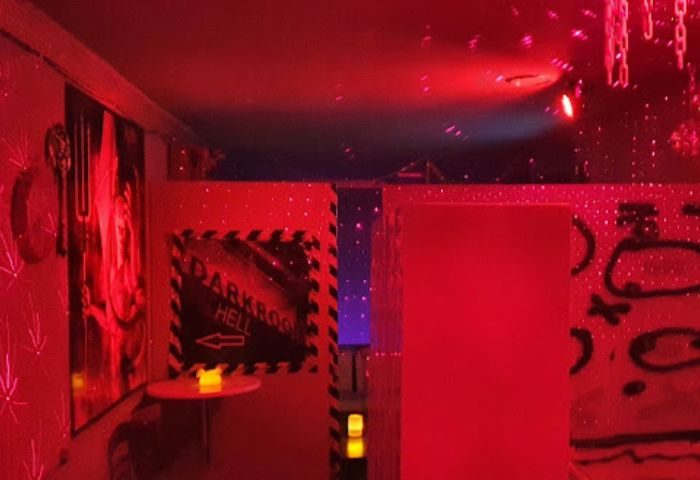 Interior of a gay cruise club in Gran Canaria. Red lighting, darkroom sign, and fetish decor create a unique atmosphere.