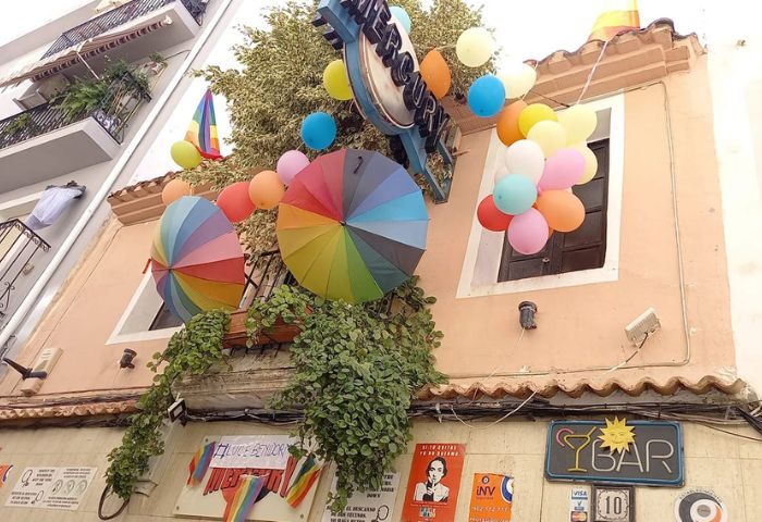 Mercury Bar, a gay party & drinks venue in Benidorm. Rainbow umbrellas, balloons, and pride flags decorate the building's exterior.