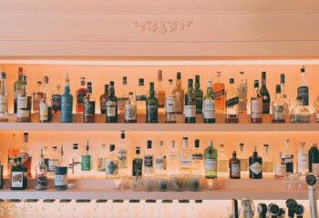 Bar Renard in Montreal: Well-stocked bar shelves with diverse liquor bottles, glasses, and bar equipment. Gay travel nightlife.