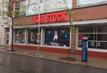 Bar Stock gay bar in Montreal. Window displays feature shirtless men. Gay stripper liveshow venue. Gay travel advice.