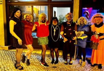 Lisbon gay travel: Group of men in drag at Bar TR3S. Nightlife scene in Lisbon, Portugal. Fun, festive atmosphere. Gay bar.