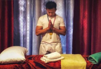 Gay massage in Barcelona: Man with prayer hands before massage table. Special gay massage for gay men visiting Barcelona.