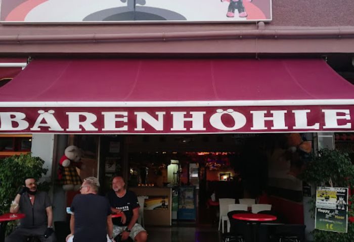 Bärenhöhle Bearcave Gay Bar in Gran Canaria. Exterior view of the popular gay bar, patrons seated outside. Gay travel destination.