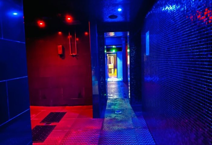 Manchester Basement Complex: Hallway with red and blue lighting. Gay travel advice for saunas, bathhouses, and cruising spots.