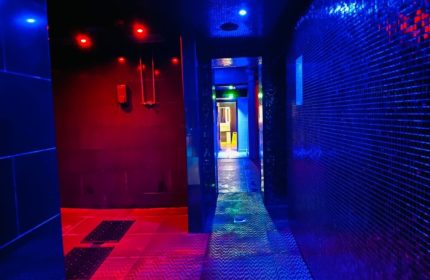 Manchester Basement Complex: Hallway with red and blue lighting. Gay travel advice for saunas, bathhouses, and cruising spots.