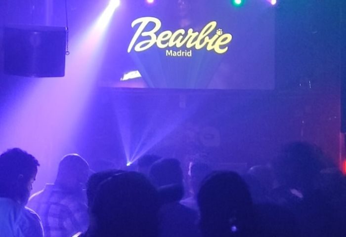 Bearbie Gay Club in Madrid, Spain. Crowd of gay men enjoying the party with lights and music. Gay travel advice.
