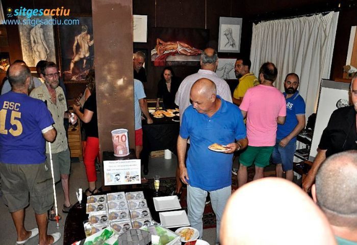 Bears Bar Sitges: Gay men gather at a Sitges gay bar, enjoying food and drinks. Art adorns the walls. Sitges, Spain gay travel.