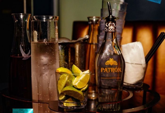 Beaux Gay Bar, San Francisco: Bar scene with Patron tequila, limes, and mixers. A popular spot for gay men's travel and nightlife.