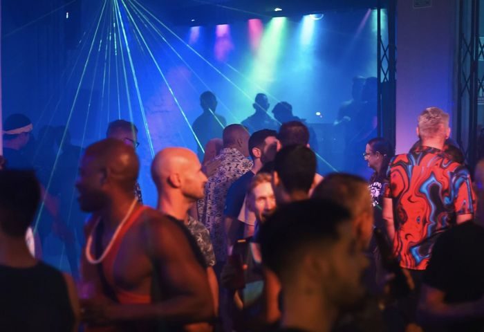 Gay nightlife at Beefcakes gay bar in Puerto Vallarta. Men gather under laser lights to dance and socialize at this popular gay travel destination.