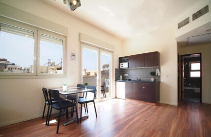 Ben Yehuda Apartments, a gay hotel in Tel Aviv. Two-bedroom penthouse apartment interior for 6 people, featuring a dining area and kitchenette.