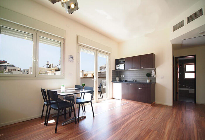Ben Yehuda Apartments, a gay hotel in Tel Aviv. Two-bedroom penthouse apartment interior for 6 people, featuring a dining area and kitchenette.