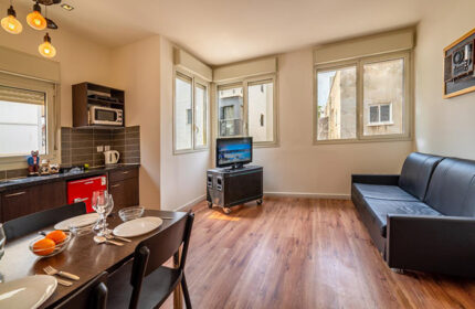 Ben Yehuda Apartments, Tel Aviv. Interior view of a service apartment near Hilton gay beach. Kitchen, dining area, and living room.