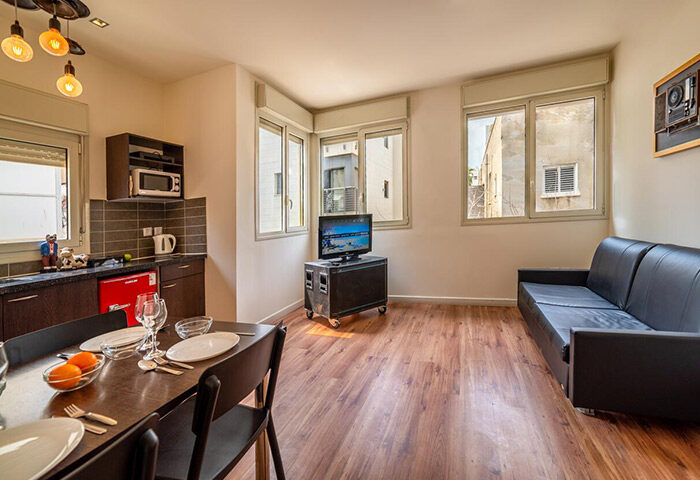 Ben Yehuda Apartments, Tel Aviv. Interior view of a service apartment near Hilton gay beach. Kitchen, dining area, and living room.