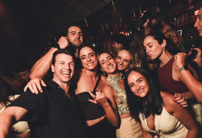 Gay travelers at Beresford Hotel Sydney. Group of friends smiling, enjoying nightlife. Gay travel advice in Sydney, Australia.