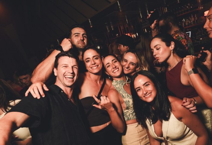 Gay travelers at Beresford Hotel Sydney. Group of friends smiling, enjoying nightlife. Gay travel advice in Sydney, Australia.