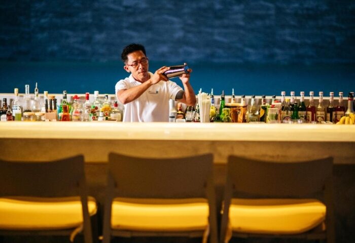 Bartender mixing drinks at Explorar Koh Samui, a gay-friendly adults-only resort. Enjoy cocktails at this best gay hotel with a private pool.