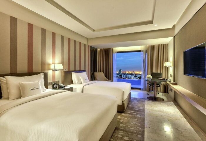 DoubleTree by Hilton Hotel Sukhumvit Bangkok room. Two beds, desk, TV, and city view. Gay travelers' choice for Bangkok nightlife.
