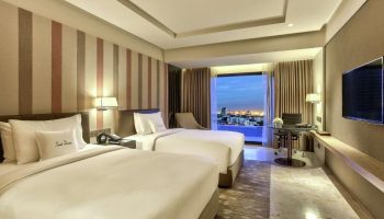 DoubleTree by Hilton Hotel Sukhumvit Bangkok room. Two beds, desk, TV, and city view. Gay travelers' choice for Bangkok nightlife.