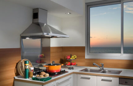 Alexander Tel Aviv Hotel kitchen. Beachfront view from window. Best gay hotel near gay bars. Modern interior, cooking pot on stove.
